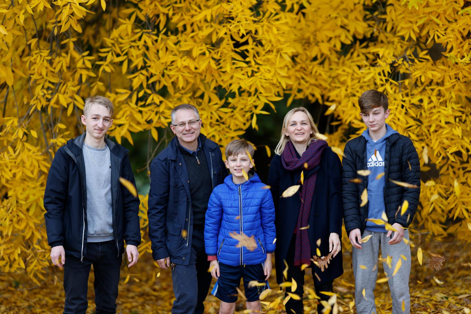 Family in autumn leaves